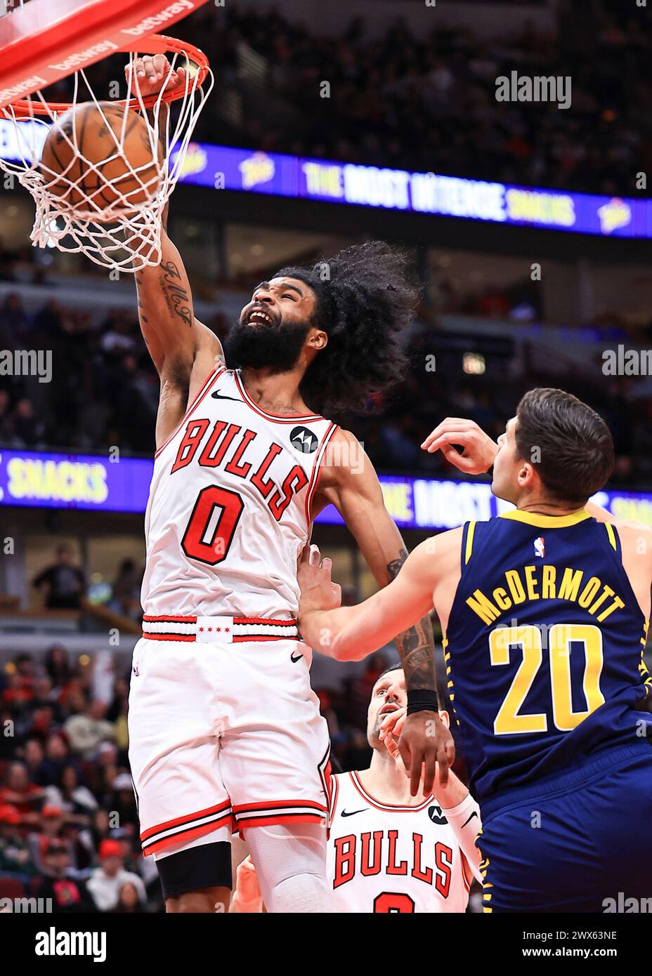 Chicago, USA. 27th Mar, 2024. Chicago Bulls' Coby White (L) dunks during the NBA regular season game between Indiana Pacers and Chicago Bulls in Chicago, the United States, March 27, 2024. Credit: Joel Lerner/Xinhua/Alamy Live News Stock Photo