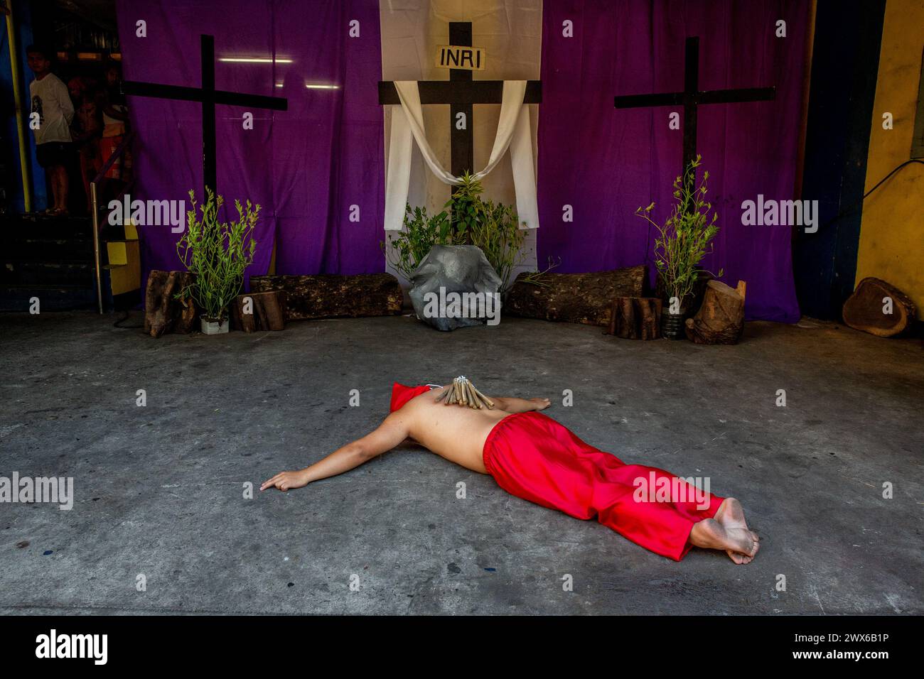 Mandaluyong City, Philippines. 28th Mar, 2024. A Filipino flagellant lies on the floor as part of his penitence on Maundy Thursday. Many Filipino Catholic devotees spend their Holy Week by doing different forms of physical penance to repent for their sins. Credit: SOPA Images Limited/Alamy Live News Stock Photo