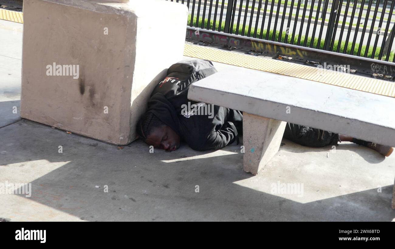 Homeless Bus Stop Los Angeles, California, USA 26th March 2024 Homeless man passed out at ...