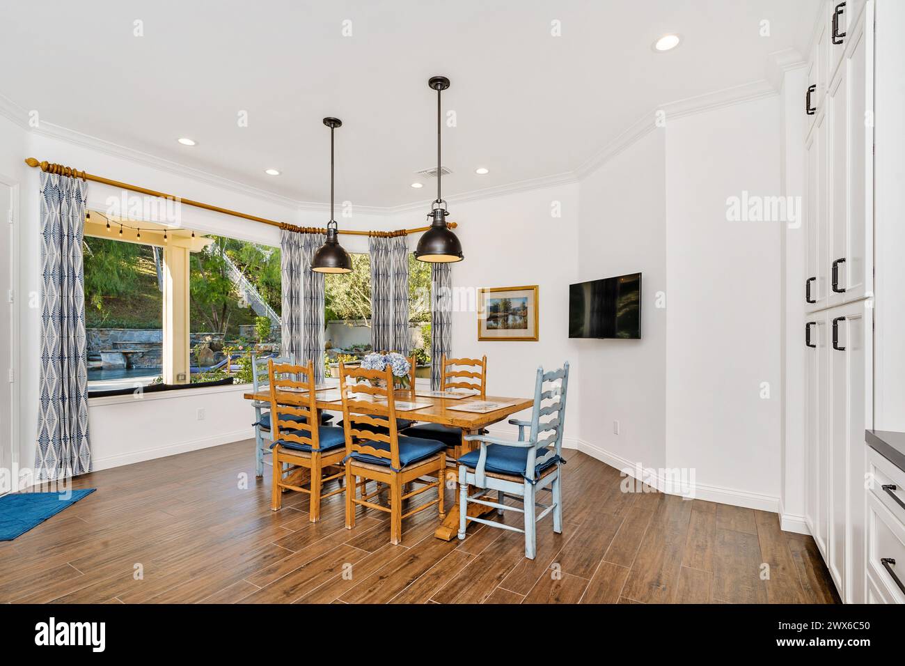 Wooden dining set by window in room Stock Photo