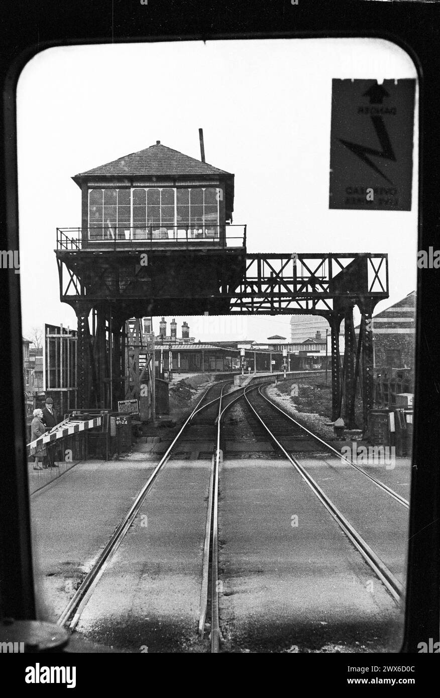 Gloucester, England: the former gantry-mounted Barton Street signal box, with Eastgate Station seen beyond, March 1974. Both signal box and station are now demolished. Viewed from the front of a passenger train. Stock Photo