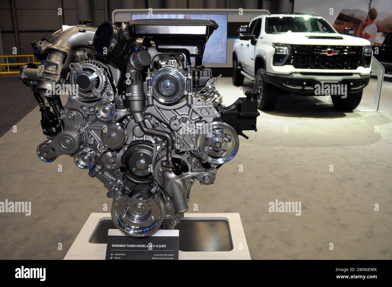 A Duramax Turbo Diesel 6.6L V-8 engine, left, is seen next to a 2024 Chevrolet Silverado HD ZR2 Bison vehicle on the first media day at the 2024 New York International Auto Show in the Jacob K. Javits Convention Center. The annual NYIAS in Manhattan, New York City featured various car companies, debuts of new vehicles and automobile industry professionals. The show which opens to the public on March 29 and ends on April 7, attracts thousands of car enthusiasts. The NYIAS began in 1900 showcasing automobiles and examples of future car technology. Stock Photo