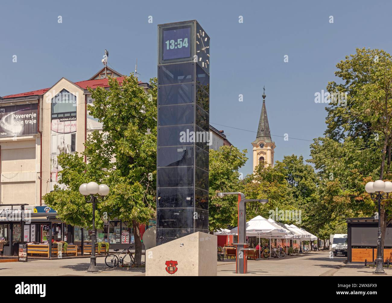 Indjija, Serbia - June 30, 2021: Modern Digital Clock Pillar and Mts WiFi Internet Station at Main Street in Town Centre Sunny Summer Day. Stock Photo