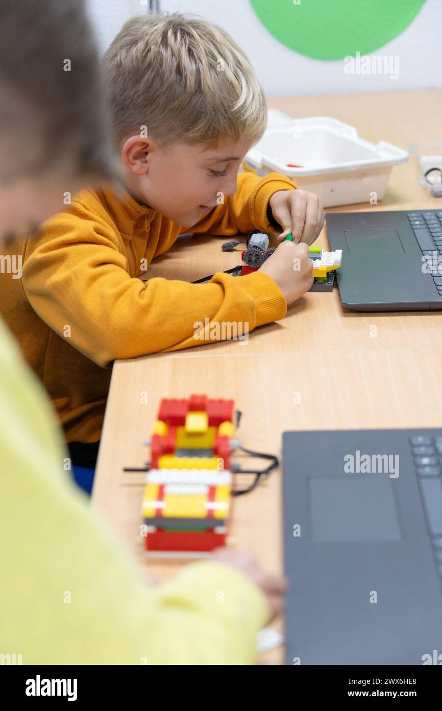 Children learning to build and program a robot in a children's robotics class Stock Photo