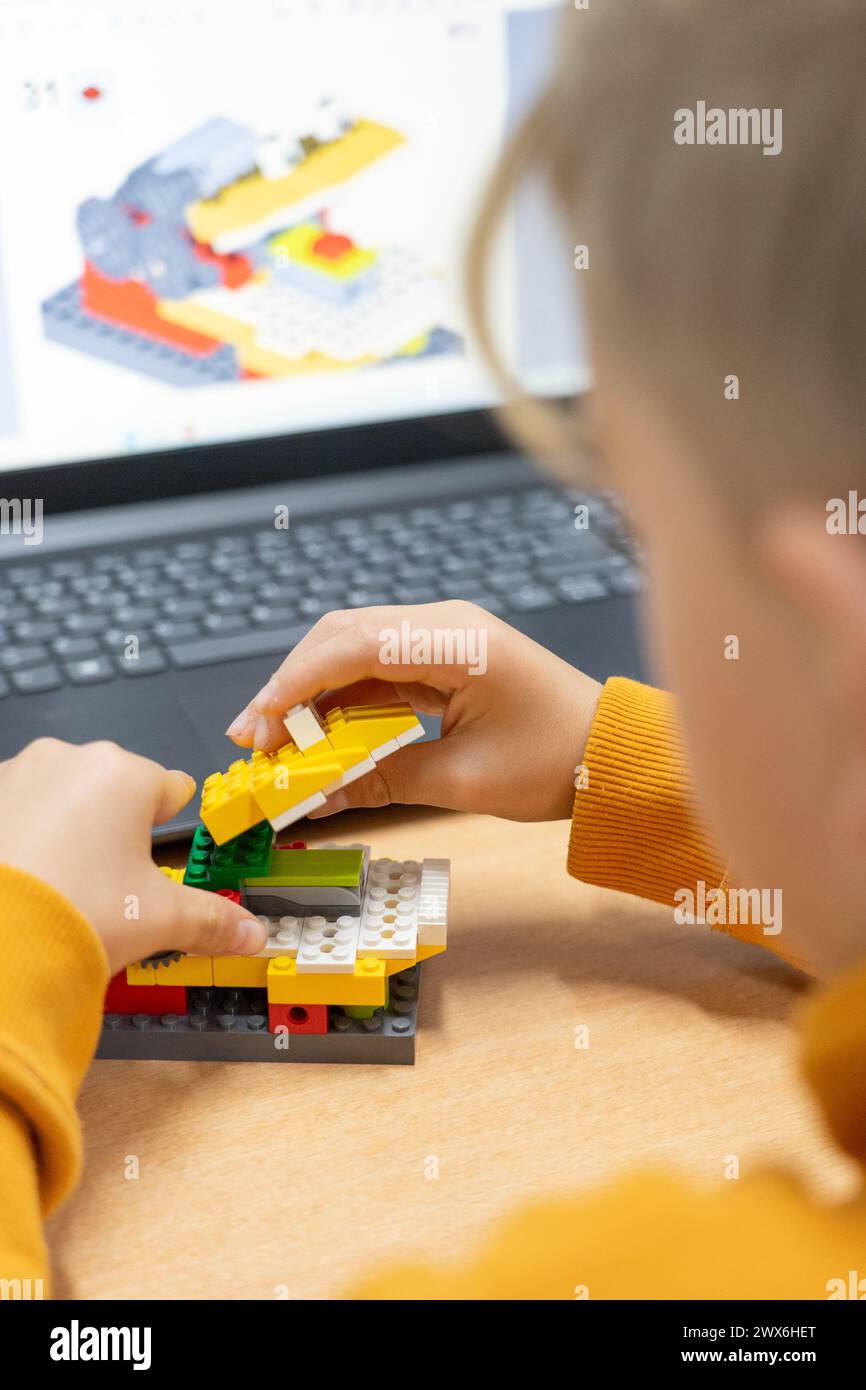 Boy creating a robot in robotics class Stock Photo - Alamy