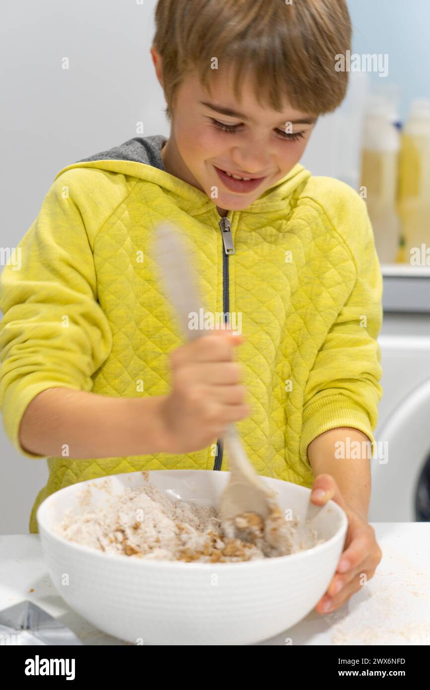 Child mixing homemade coo…