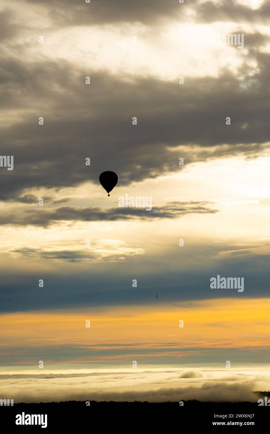 Hot air balloon flying at dawn Stock Photo