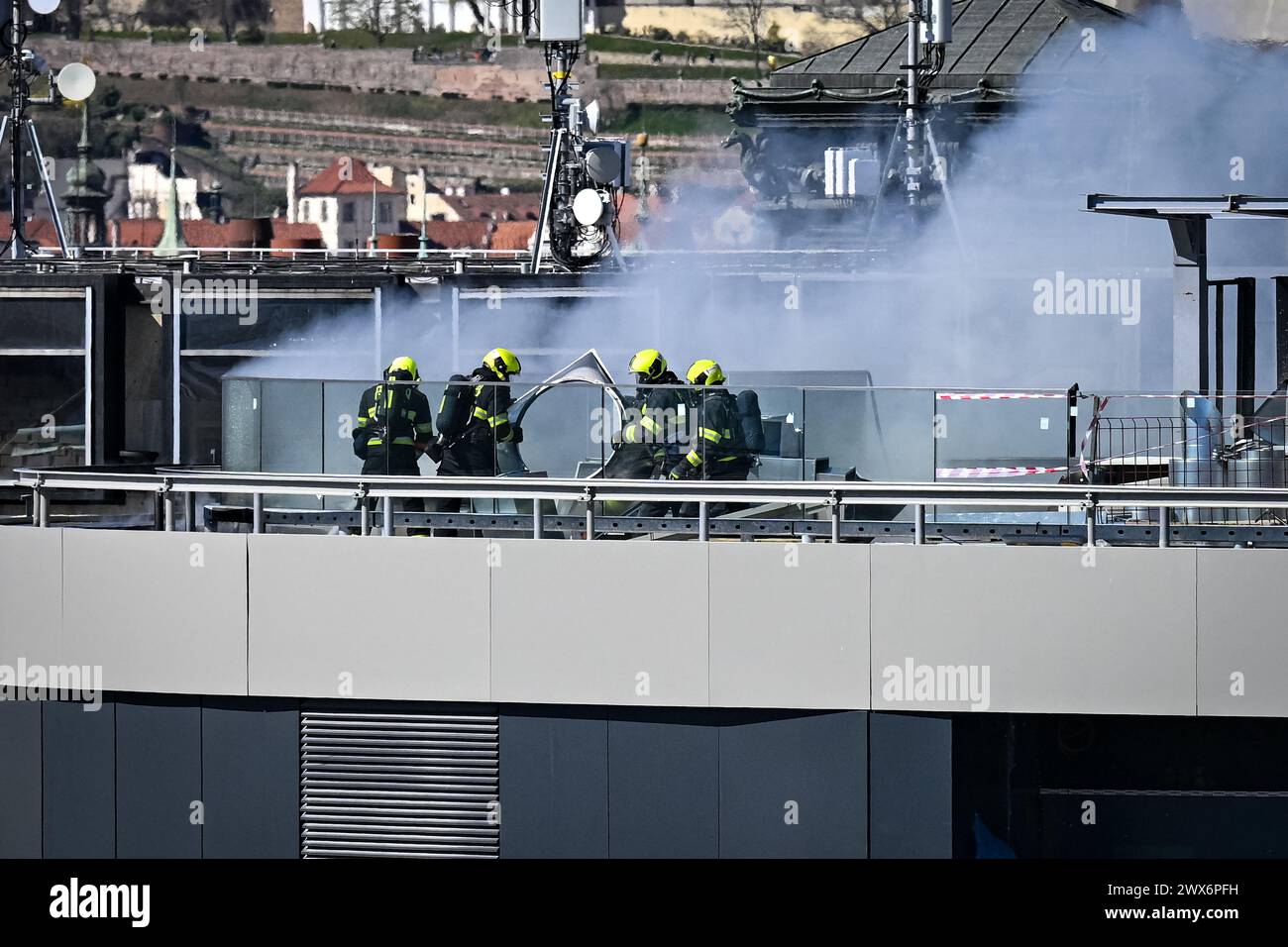 Prague, Czech Republic. 28th Mar, 2024. Firefighters intervene at a fire on the roof of a building in the central part of Wenceslas Square in Prague, Czech Republic, on March 28, 2024. Cardboard on the roof caught fire, thick smoke was visible from far away. Credit: Vit Simanek/CTK Photo/Alamy Live News Stock Photo