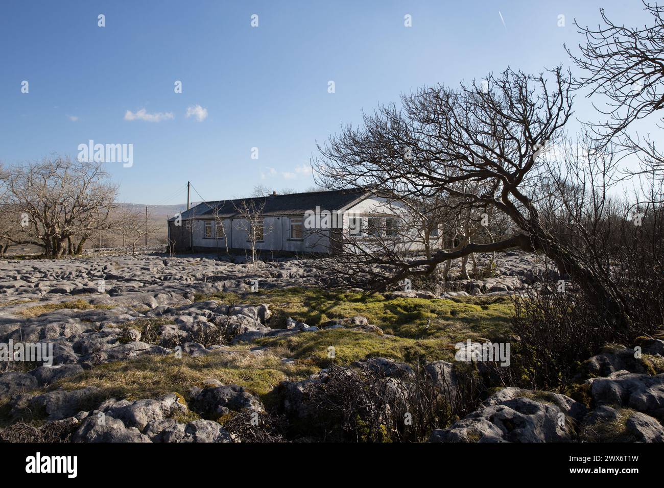 A remote building / outdoor centre sat on a mossy limestone pavement in the North Yorkshire countryside, UK, taken on a beautiful sunny day Stock Photo