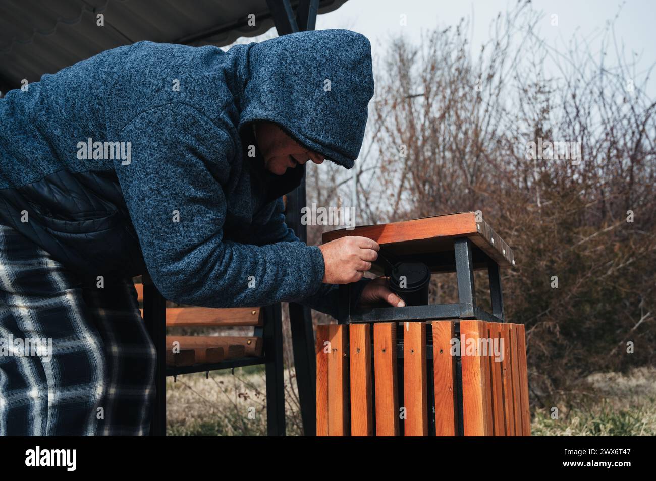 Poor man rummaging garbage in hi-res stock photography and images - Alamy