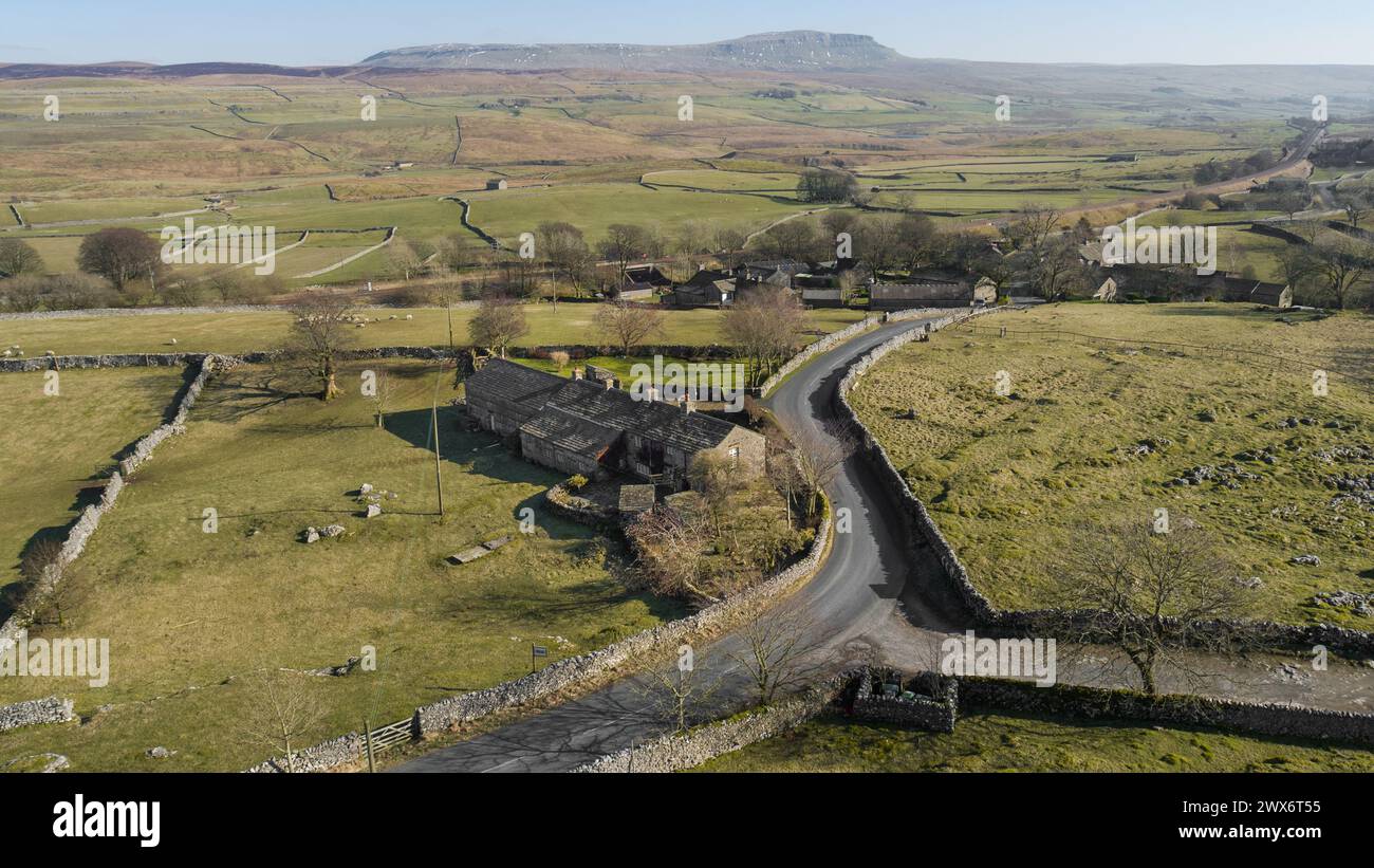 Aerial image of Pen-y-ghent mountain & the North Yorkshire countryside, with the rural village of Selside, country lanes & farmland in the foreground Stock Photo