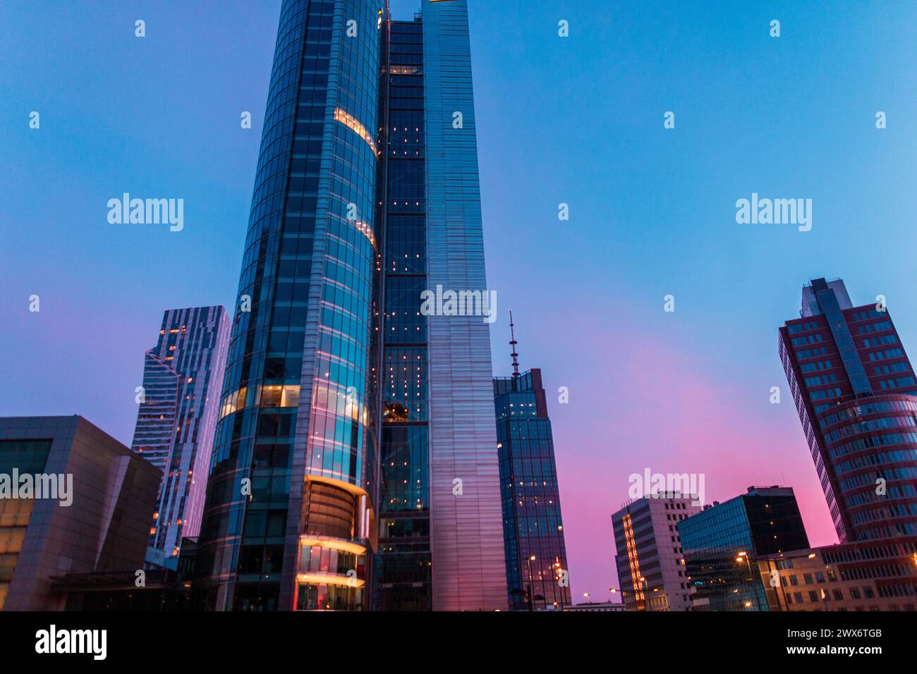 Beautiful Modern City Of Warsaw With Office And Business Buildings On An Amazing Evening Sunset Sky With Pink And Blue Colors Stock Photo