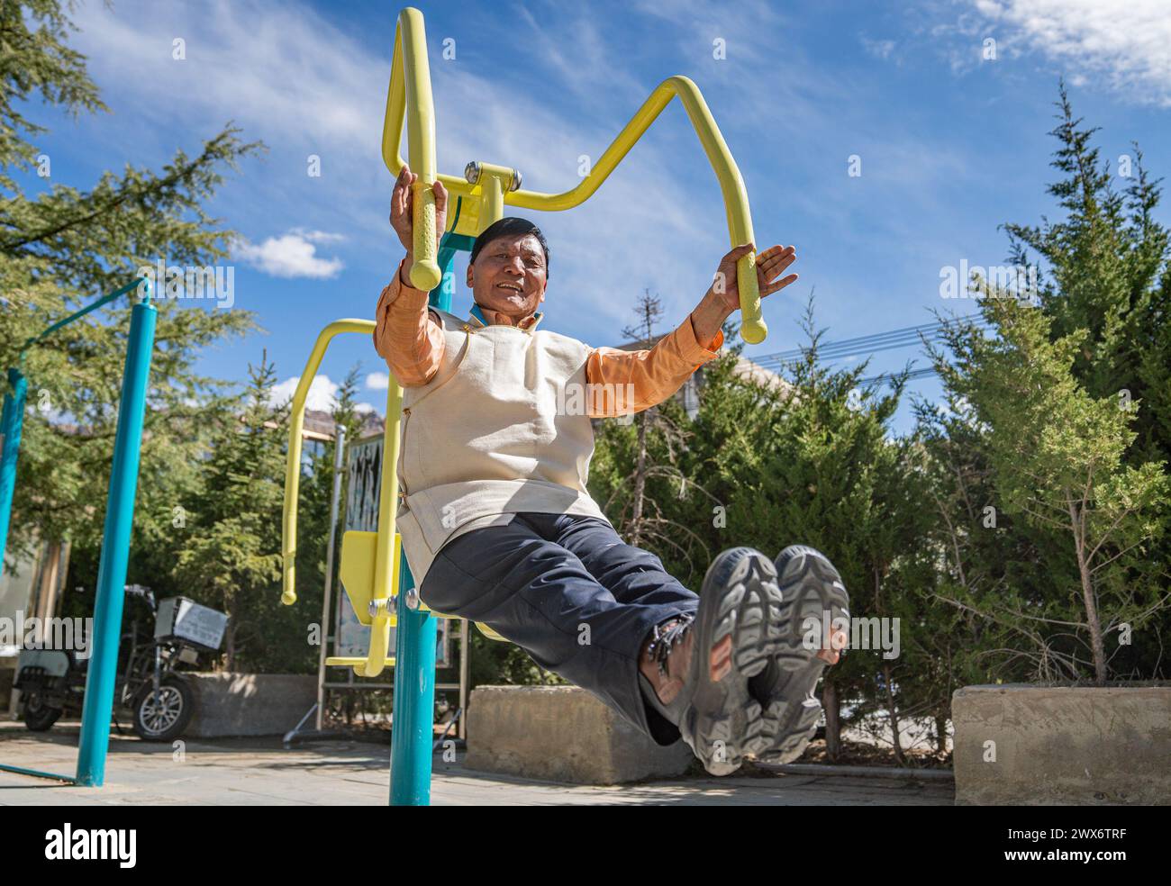 (240328) -- LHASA, March 28, 2024 (Xinhua) -- Phutsering exercises at his neighborhood in Lhasa, southwest China's Xizang Autonomous Region, March 23, 2024. Born in 1944 in Bainang County of Xigaze City, Phutsering was raised in a former serf family. A humble shack, situated near the manor where his mother toiled as a serf, served as his childhood home. Meanwhile, his father, employed at a separate manor, struggled to make ends meet by farming and crafting during lean months, barely generating sufficient income to cover the rent and taxes for their dwelling and fields. At the age of thirteen, Stock Photo