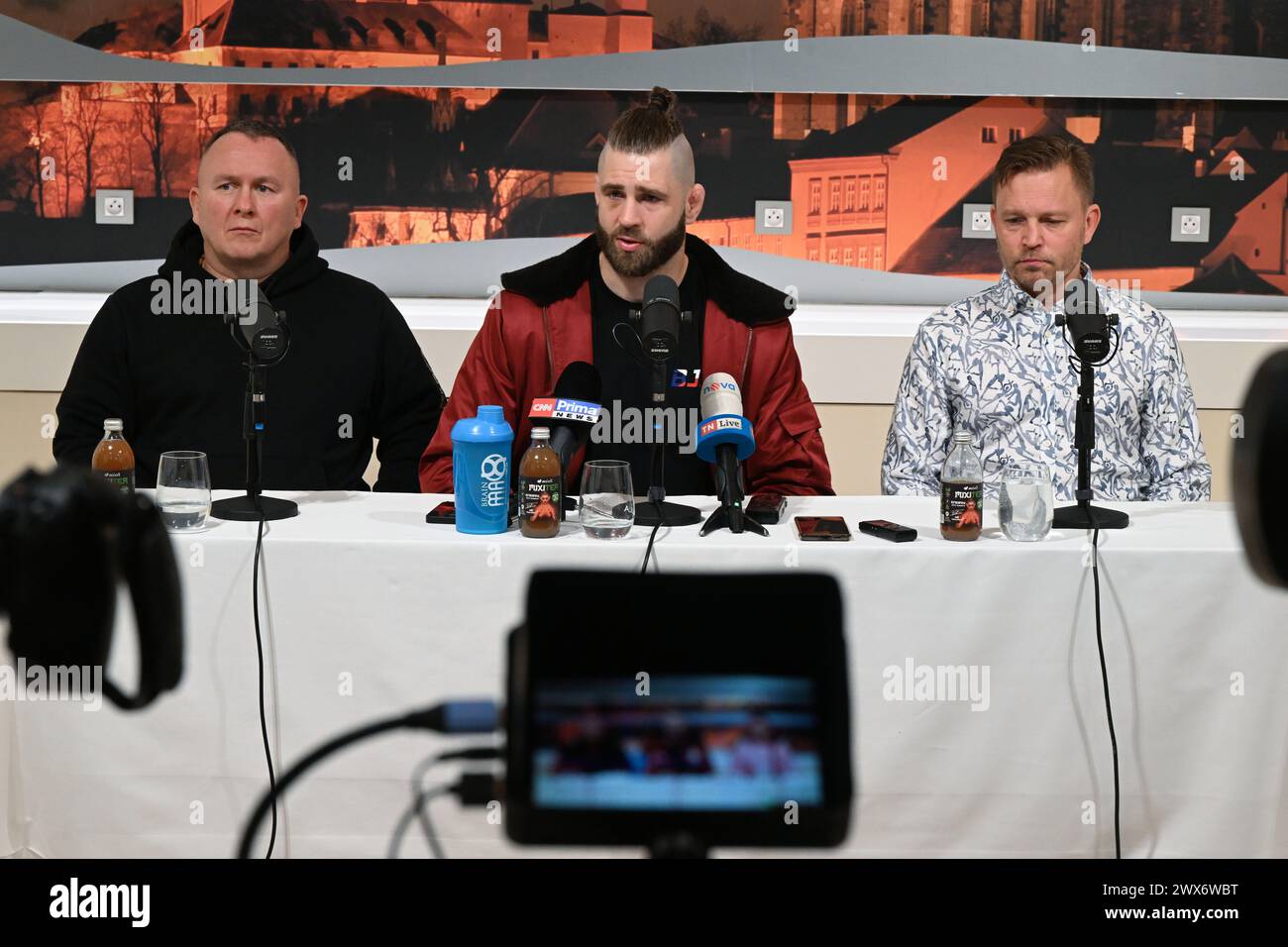 Brno, Czech Republic. 28th Mar, 2024. Czech MMA fighter Jiri Prochazka, center, speaks during a meeting with journalists ahead of the BJP team's scheduled departure for UFC 300 in Las Vegas, USA, on March 28, 2024, in Brno, Czech Republic. On the left side is seen coach Jaroslav Hovezak and on the right coach Martin Karaivanov. Credit: Vaclav Salek/CTK Photo/Alamy Live News Stock Photo
