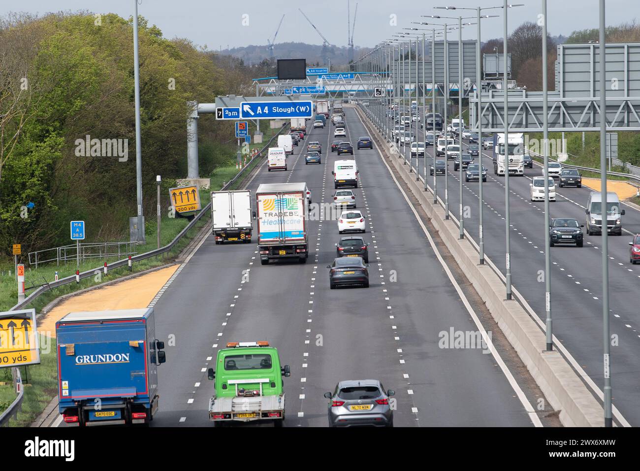 Slough, Berkshire, UK. 28th March, 2024. Traffic on the M4 Smart Motorway in Slough, Berkshire this morning before the rain started. Motorways are expected to get very busy over the Easter Bank Holiday Weekend as schools break up and people head off on holidays. Credit: Maureen McLean/Alamy Live News Stock Photo