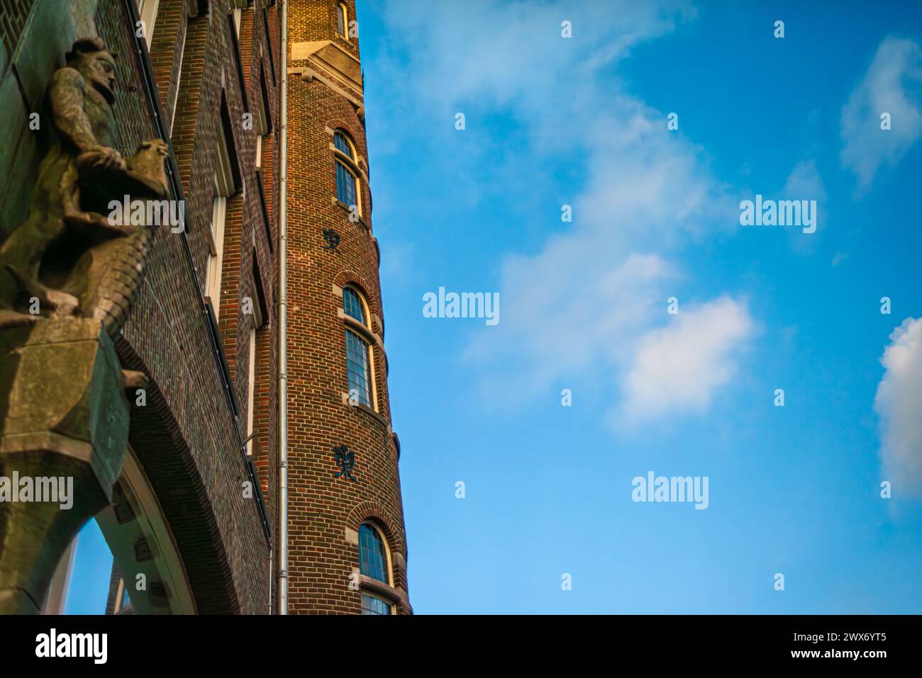 Explore the charm and architectural heritage of Amsterdam through its vibrant streets, where iconic buildings paint a picturesque cityscape. Stock Photo