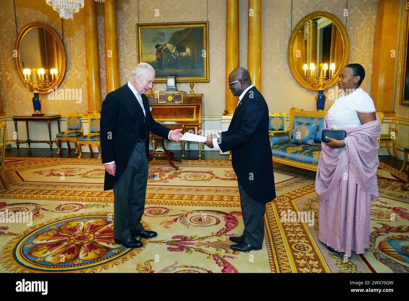 The Ambassador of Burundi, Epimeni Bapfinda presents his credentials to King Charles III (left) during a private audience at Buckingham Palace, London. Picture date: Thursday March 28, 2024. Stock Photo