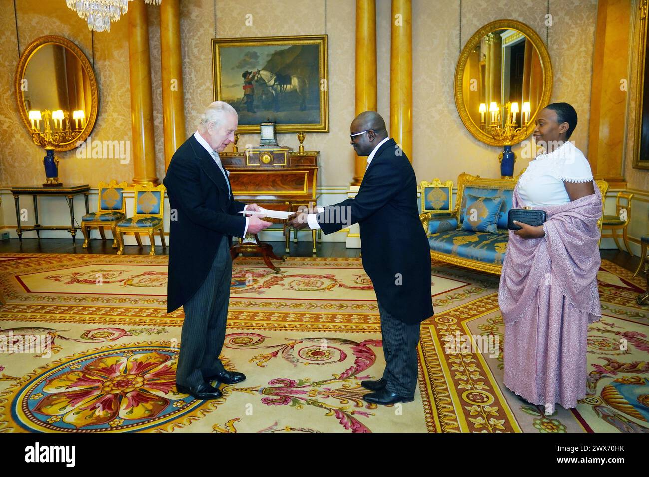 The Ambassador of Burundi, Epimeni Bapfinda presents his credentials to King Charles III (left) during a private audience at Buckingham Palace, London. Picture date: Thursday March 28, 2024. Stock Photo