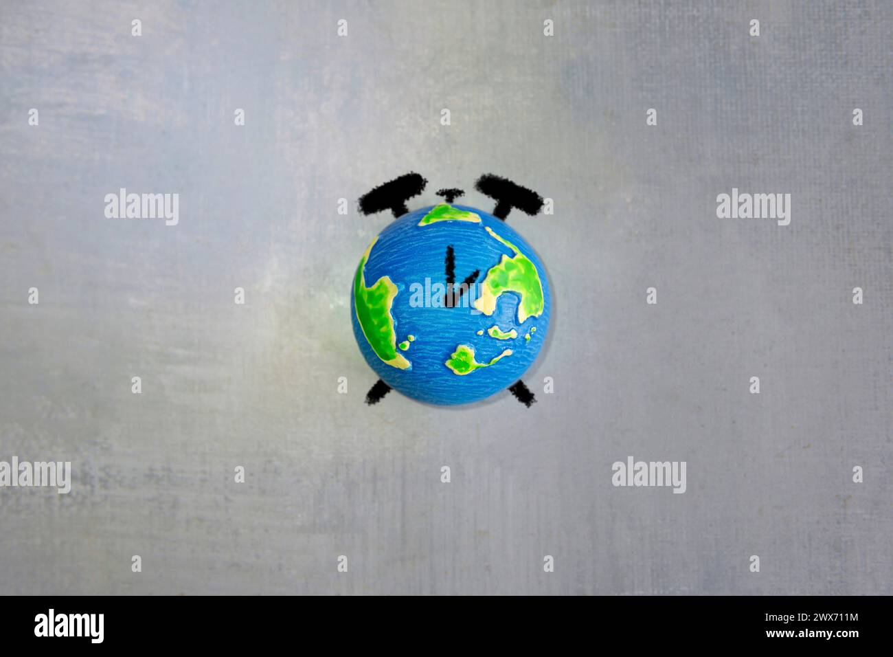 Drawing of alarm clock and world globe with copy space. Earth hour, earth day and time zone concept. Stock Photo