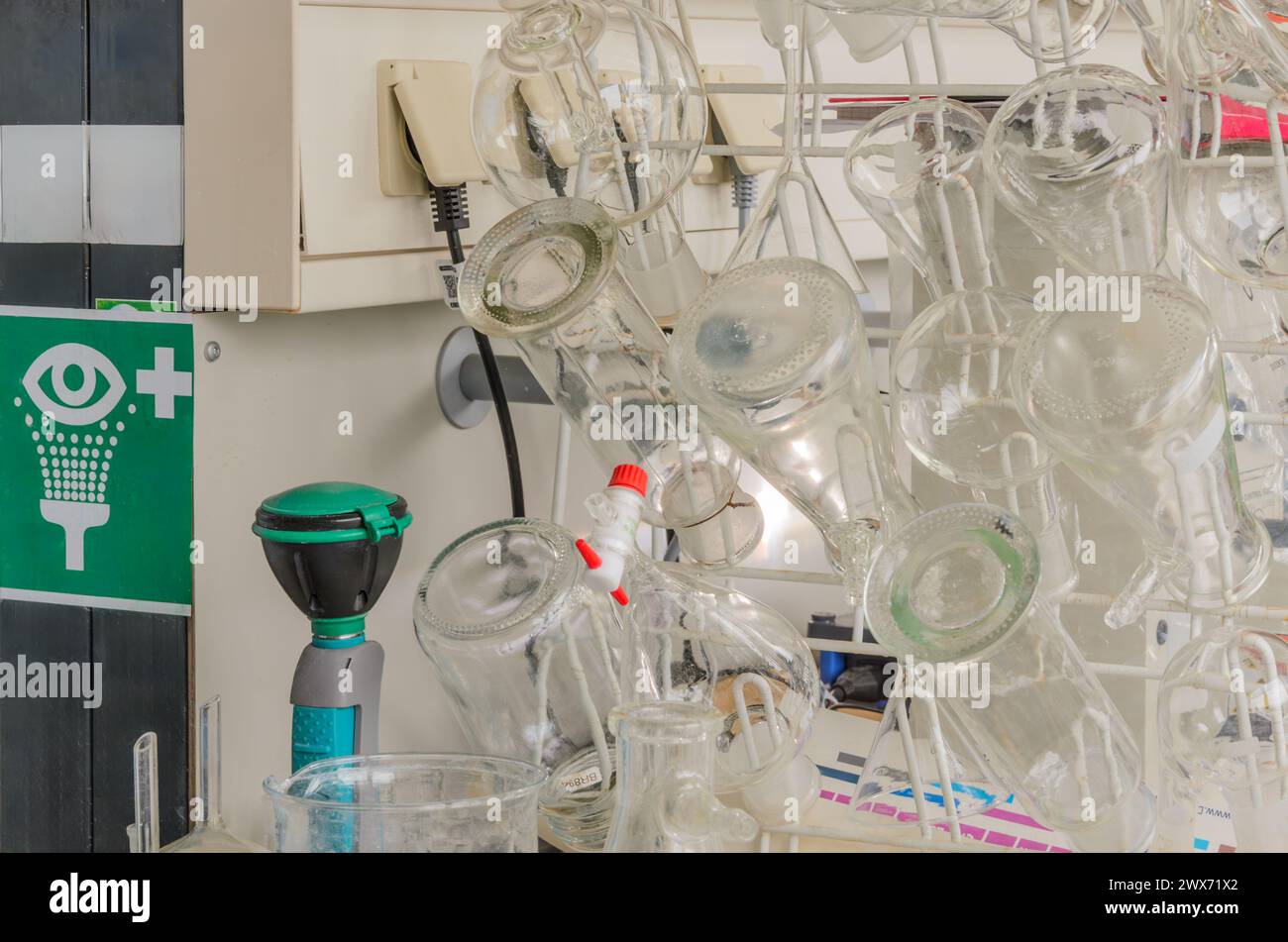 Lab Glassware on Metal Rack and eye shower sign Stock Photo - Alamy