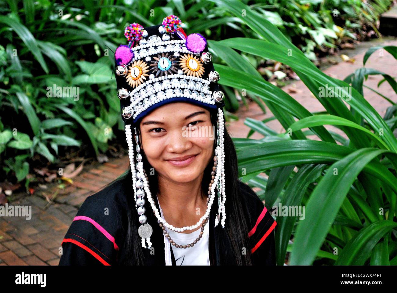 akha, women with headdress and traditional clothing in village in Chiang Rai, northern Thailand Stock Photo