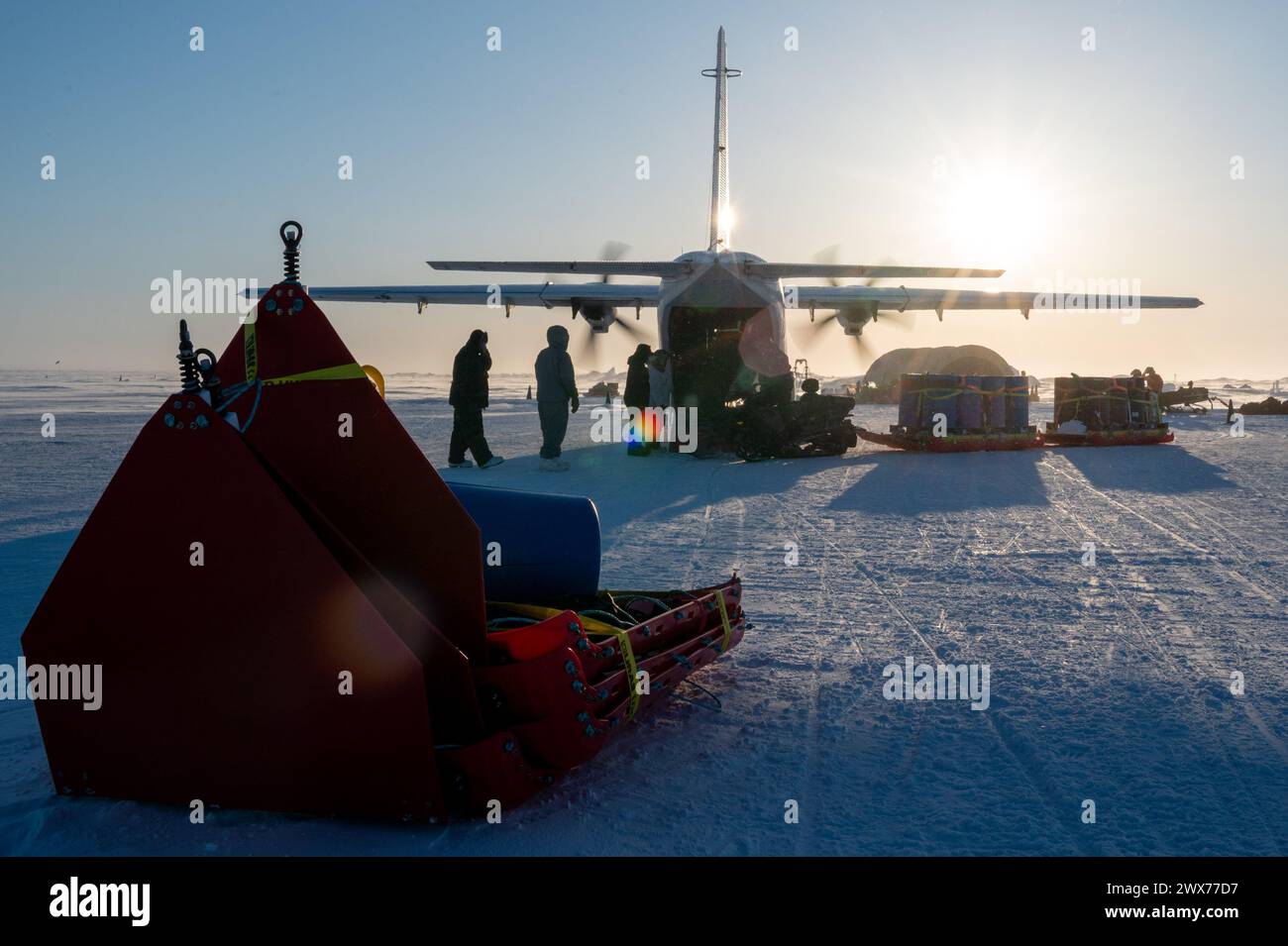 Personnel participating in Operation Ice Camp unload supplies from a Casa C-212 Aviocar of CHI Aviation at Ice Camp Whale, near Prudhoe Bay, Alaska Stock Photo