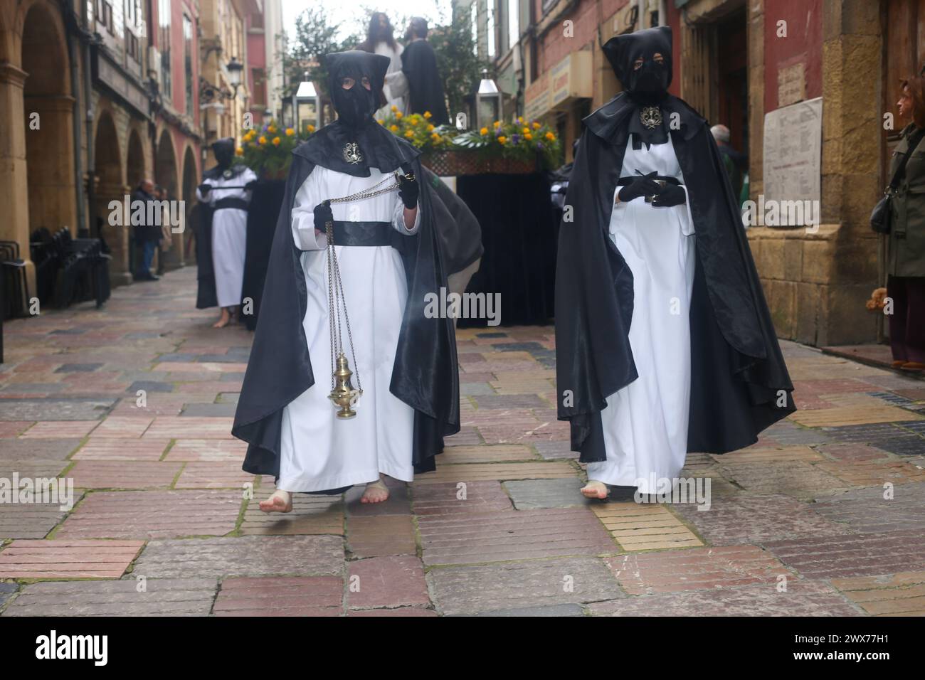 Aviles, Spain, March 28, 2024: Two Nazarenes carry incense during the Judas Kiss Procession, on March 28, 2024, in Aviles, Spain. Credit: Alberto Brevers / Alamy Live News. Stock Photo