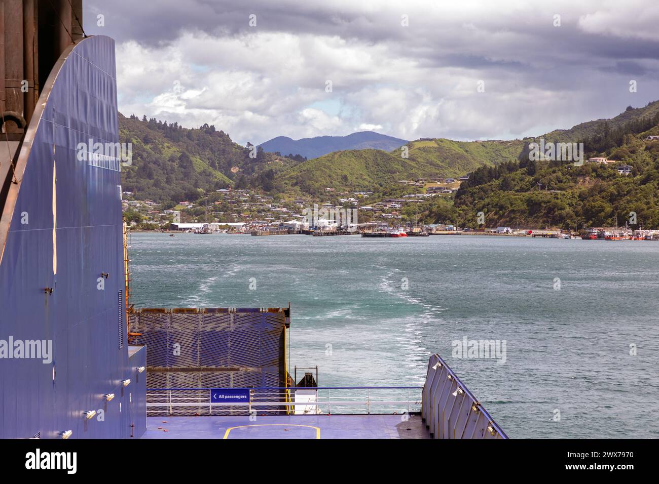 The town of Picton on the north end of the South Island of New Zealand is seen from a ferry headed to the Cook Strait and Wellington. Stock Photo