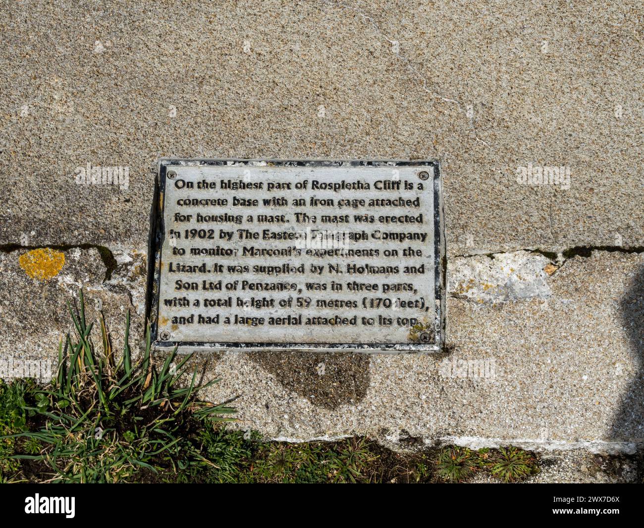 Plaque at site of aerial mast socket on top of Rospletha Cliff Porthcurno used in 1902 to monitor Marconi's radio experiments. See also 2WX7D70 Stock Photo