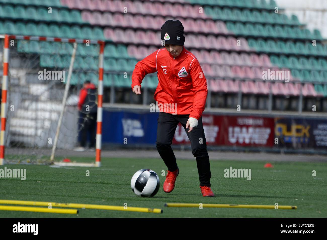 Kyiv, Ukraine. 28th Mar, 2024. A youth of FC 'Lokomotyv' Kyiv trains on the football field during the visit of the mayor of Paris, Anne Hidalgo, to the stadium. The Mayor of Paris, Anne Hidalgo, visited Kyiv and visited FC Lokomotiv Kyiv, whose sports complex was damaged by a Russian missile attack on January 23, 2024. The mayor observed how the players of different age teams train on the field, and at the end took a joint photo with the football players. (Photo by Aleksandr Gusev/SOPA Images/Sipa USA) Credit: Sipa USA/Alamy Live News Stock Photo