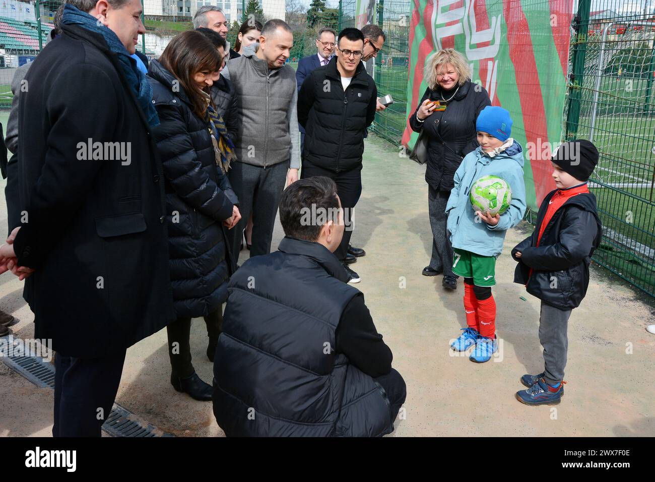 The director of the club, Oleksandr Egorov, tells the mayor of Paris, Anne Hidalgo, about the tragic day on January 23, 2024, when a rocket hit the sports complex. The Mayor of Paris, Anne Hidalgo, visited Kyiv and visited FC Lokomotiv Kyiv, whose sports complex was damaged by a Russian missile attack on January 23, 2024. The mayor observed how the players of different age teams train on the field, and at the end took a joint photo with the football players. (Photo by Aleksandr Gusev / SOPA Images/Sipa USA) Stock Photo