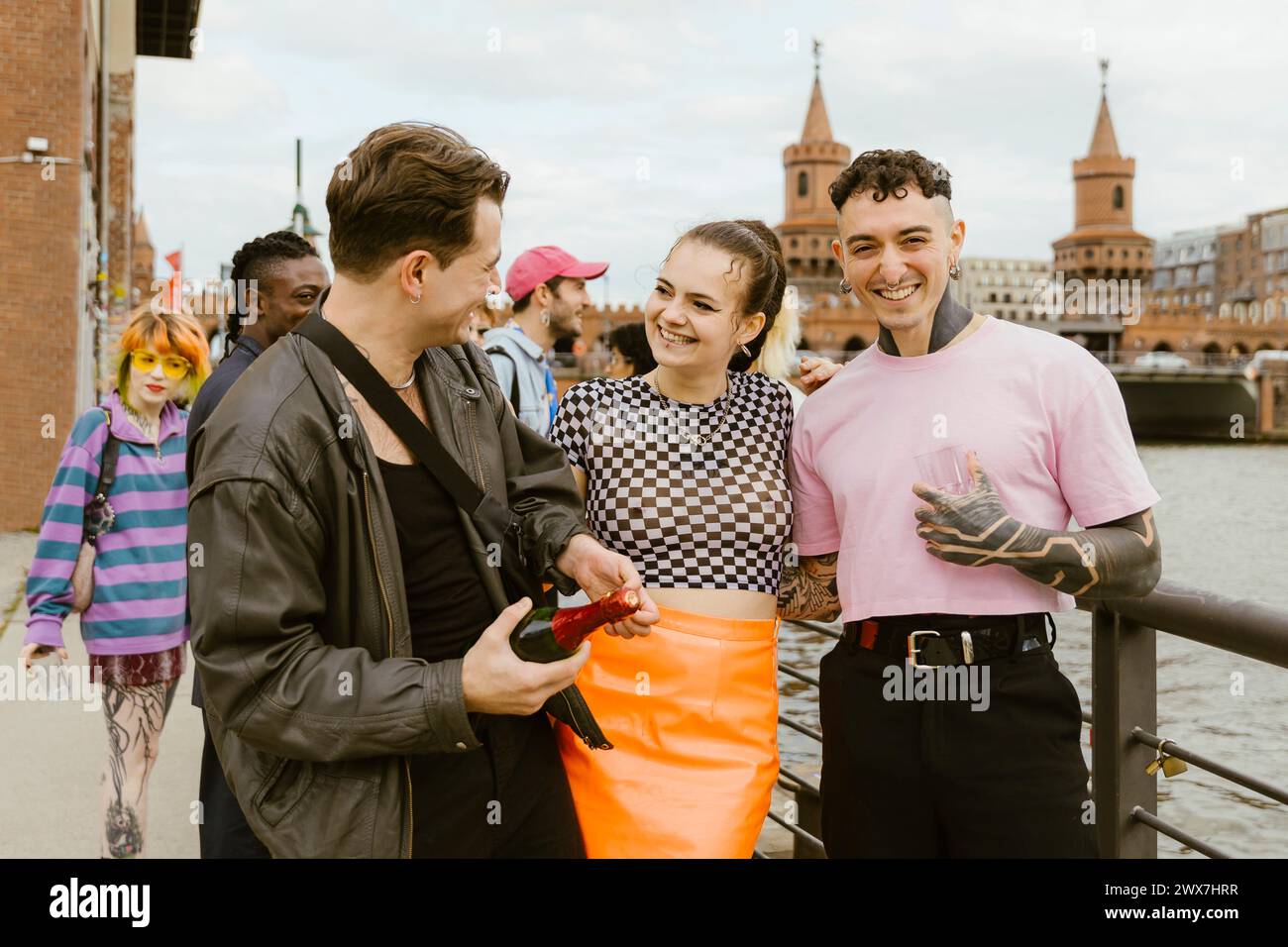 Cheerful non-binary friends enjoying and having fun in city Stock Photo