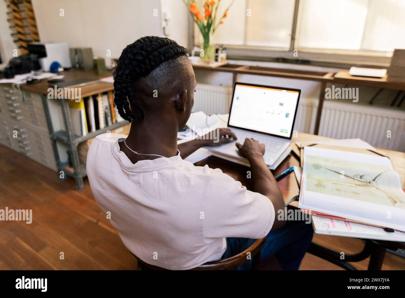 Businessman using laptop while working at table in home office Stock Photo