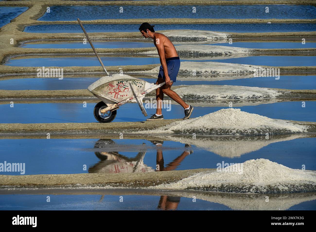 France, Brittany, A man extracting salt in Salants de Guerande Stock Photo