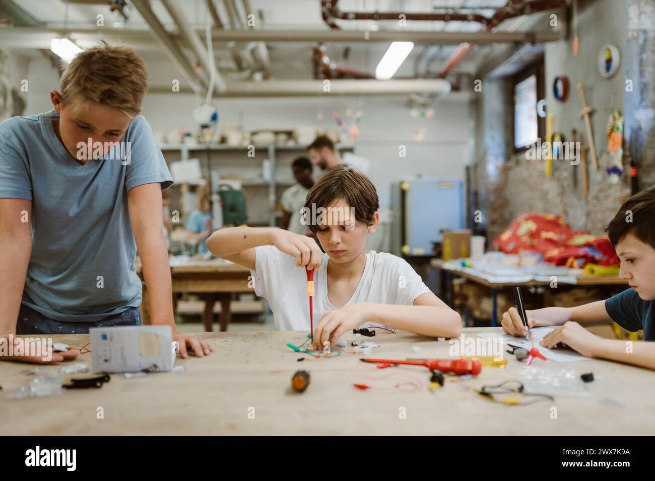 Boys working on robotics project in workshop at school Stock Photo
