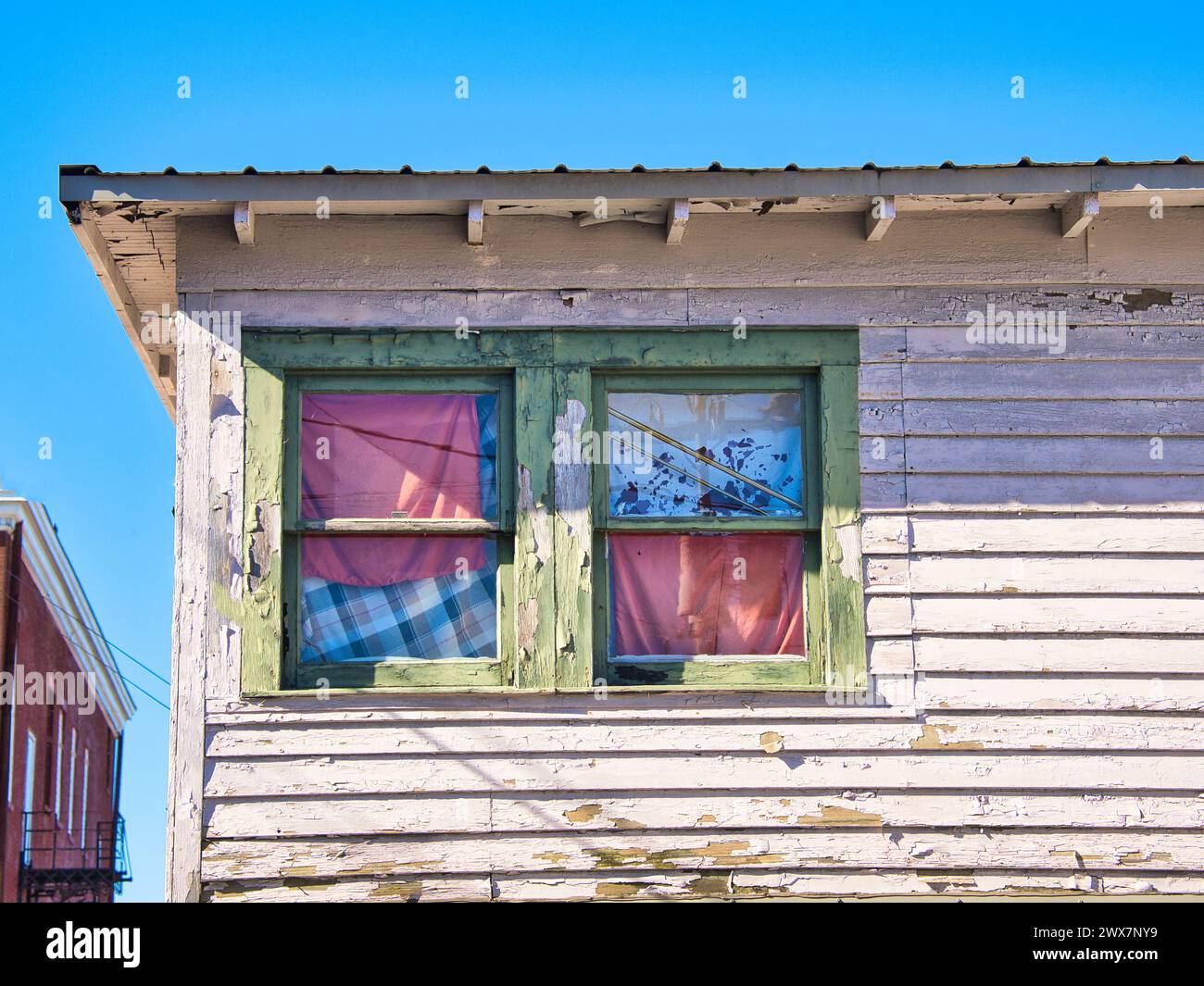 Old window's of an abandoned building covered by blanket's Stock Photo
