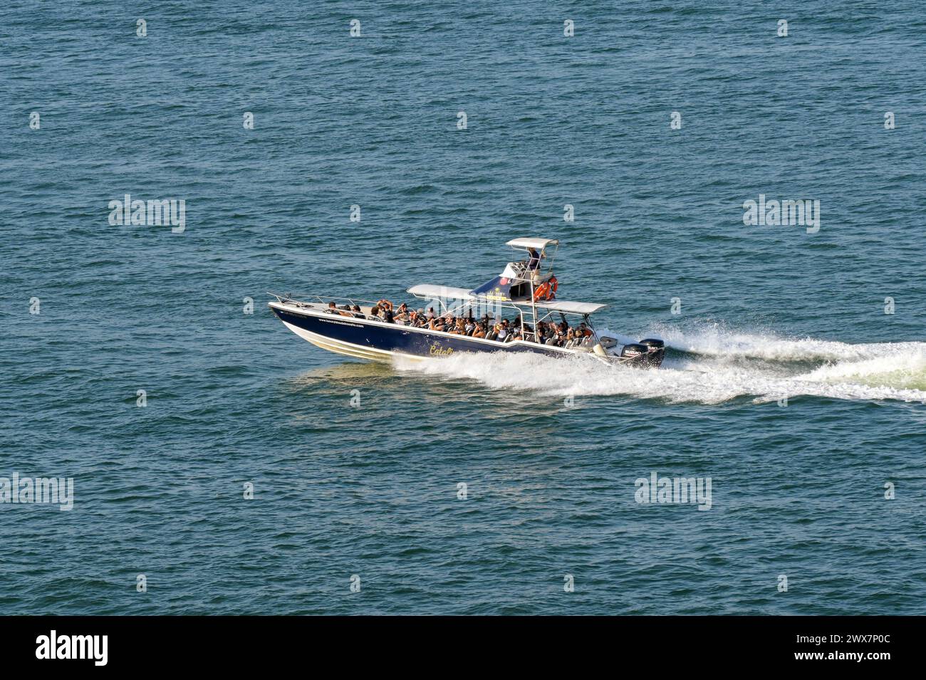 Cartagena, Colombia - 24 January 2024: Fast motorboat at speed taking tourists on a trip around the bay Stock Photo