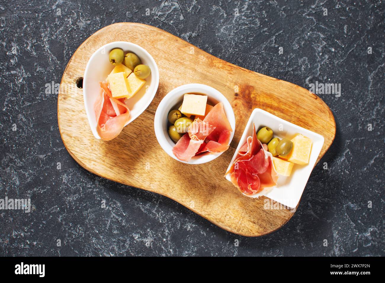 Traditional spanish jamon and cheese. Antipasto plate and olives. Stock Photo