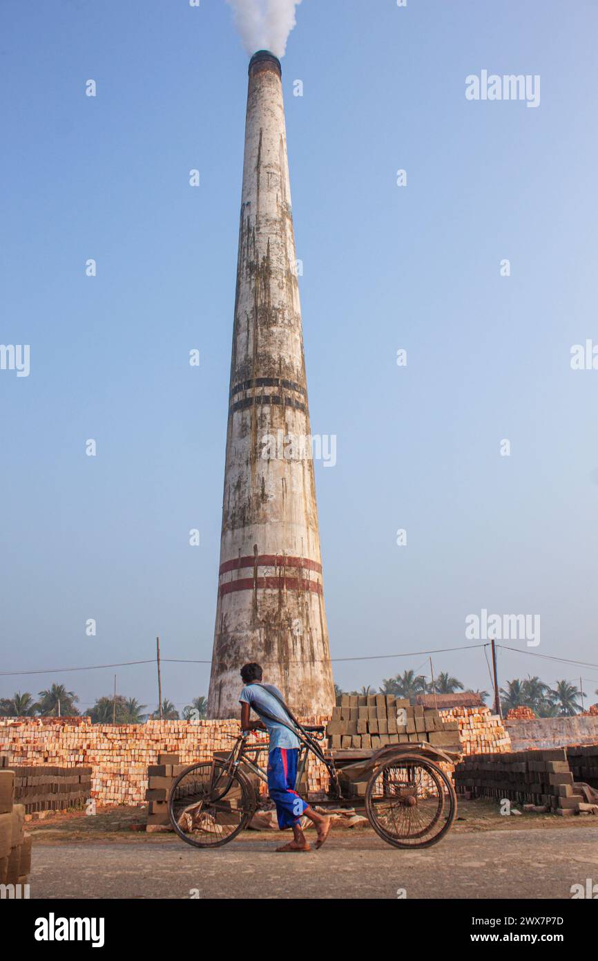 A worker carries bricks at brickfield at Khulna, Bangladesh. Stock Photo