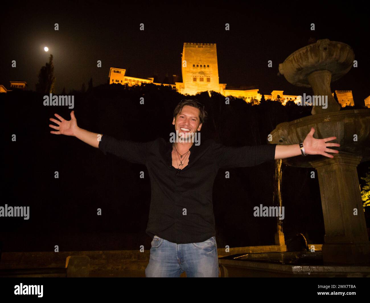 man in his thirties invites night visits to the Alhambra in Granada Spain Stock Photo