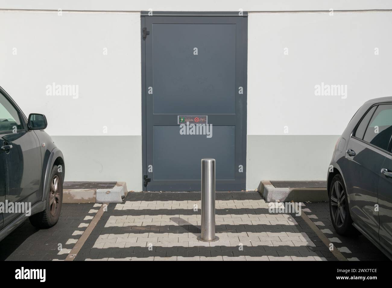 emergency exit pedestrian crossing and parking bollard to avoid obstructions to people exiting. pedestrian crossing. Stock Photo