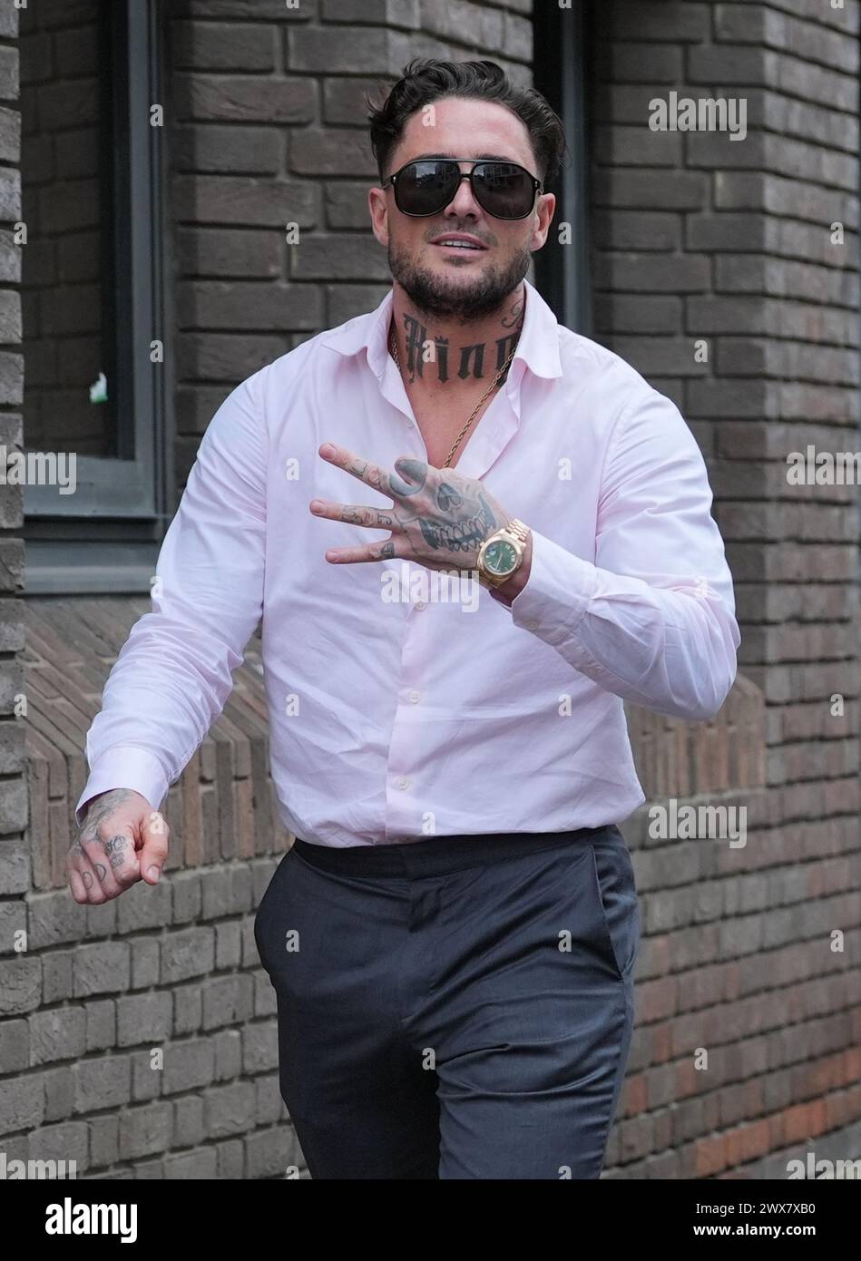 Stephen Bear, makes a gesture as he leaves Chelmsford Crown Court, Essex, after his confiscation hearing following his conviction for voyeurism and two counts of disclosing private sexual photographs and films with intent to cause distress, and for posting a CCTV video of himself and The Only Way Is Essex star Georgia Harrison having sex. Picture date: Thursday March 28, 2024. Stock Photo