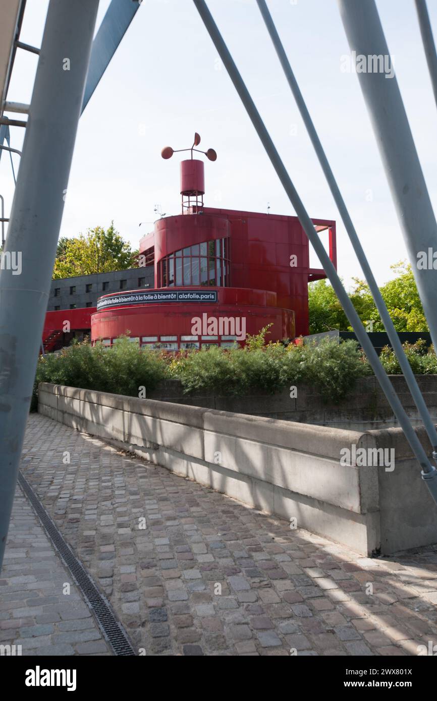 Parc De La Villette, Paris. In the background, one of the 'Folies', red construction built like the playful constructions of 18th-century parks and gardens. Stock Photo