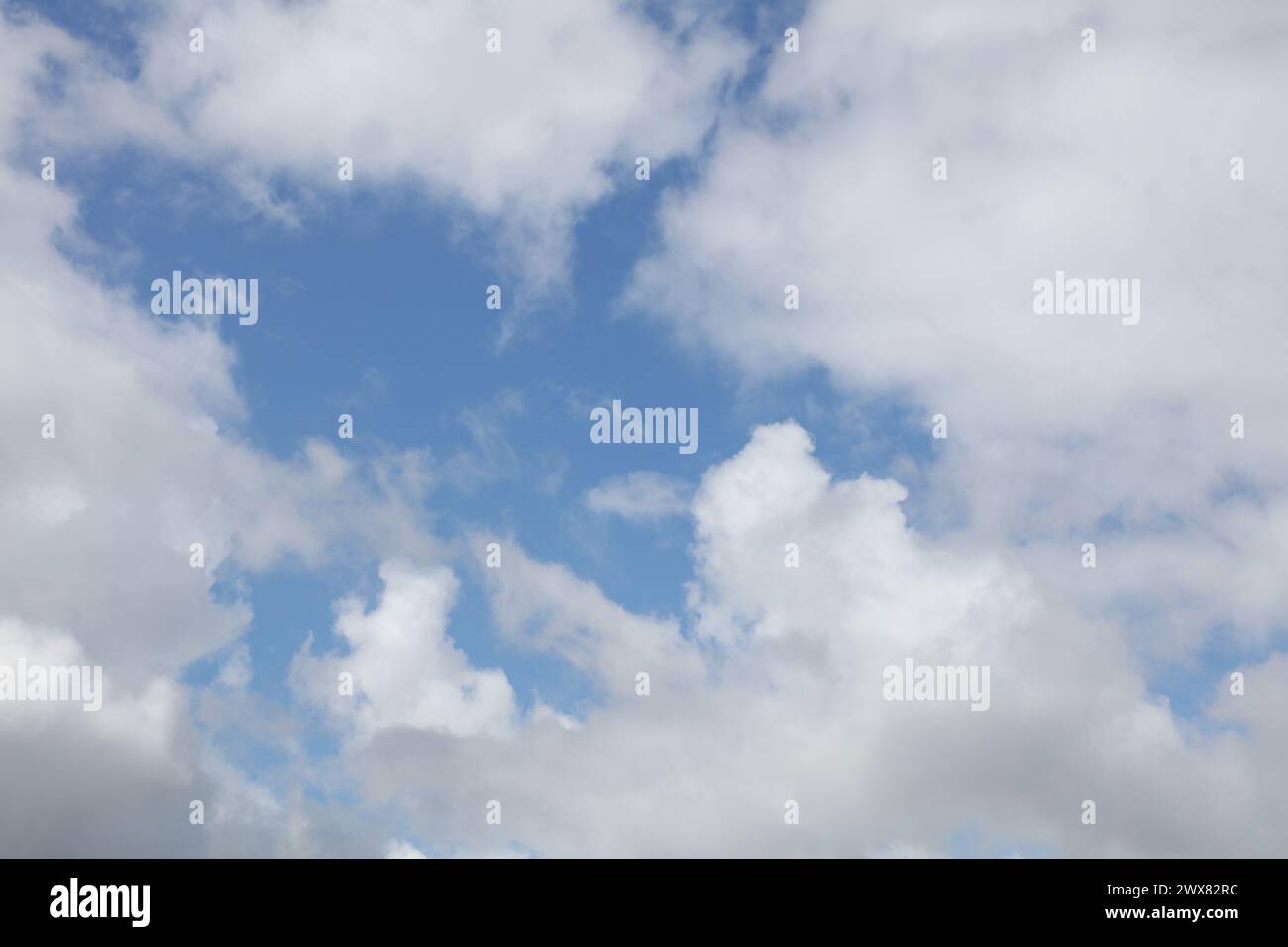 Fluffy white clouds in a blue sky Stock Photo