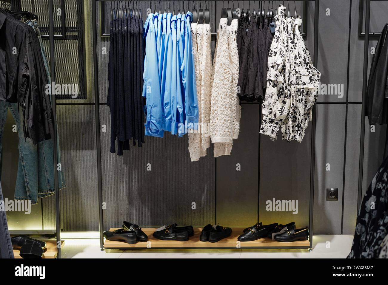 Women's clothes and shoes in a retail shop. Fashion and shopping concept Stock Photo