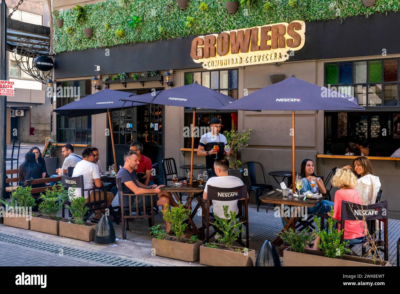 Young People Sitting Outside Growlers Pub/Bar, Buenos Aires, Argentina. Stock Photo