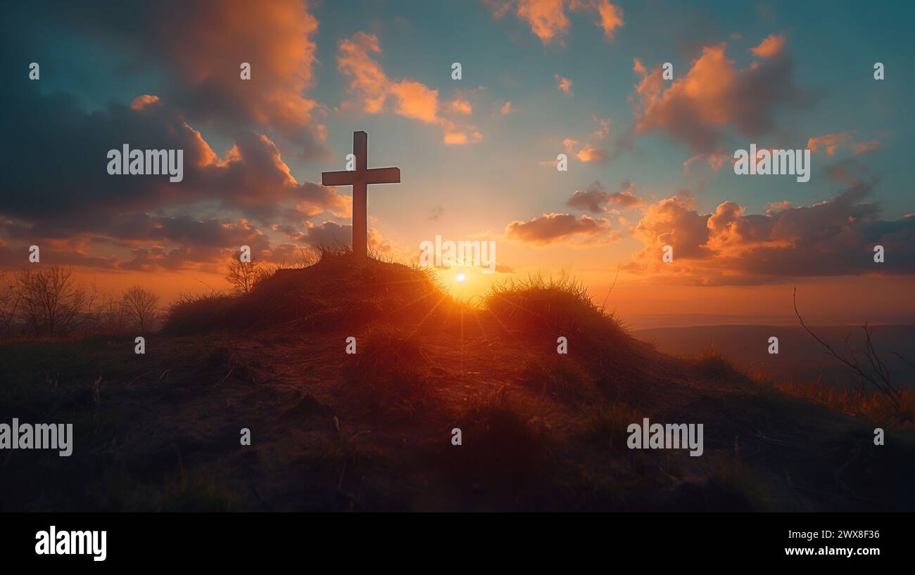 Cross on a hill at sunset with clouds on blue sky . Easter, resurrection, new life, redemption concept. Stock Photo