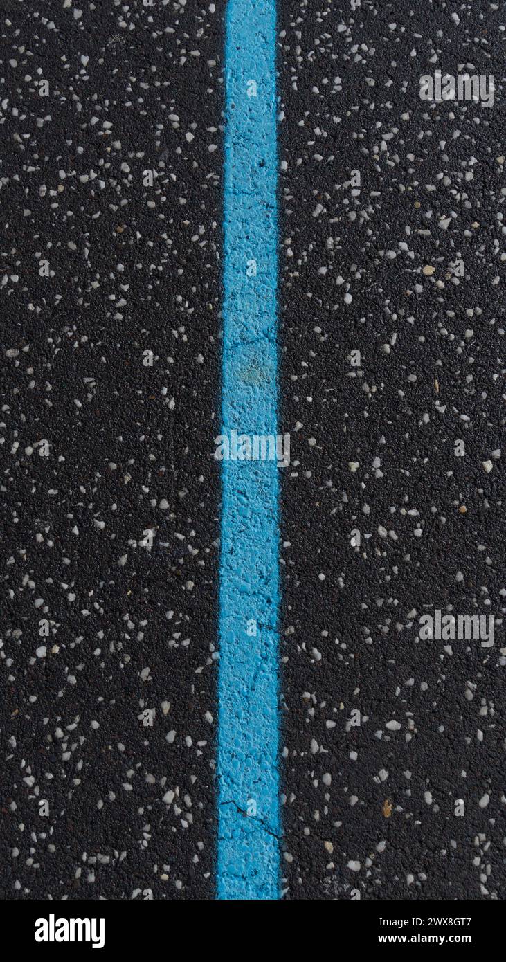 Bright blue line, textured asphalt road Stock Photo