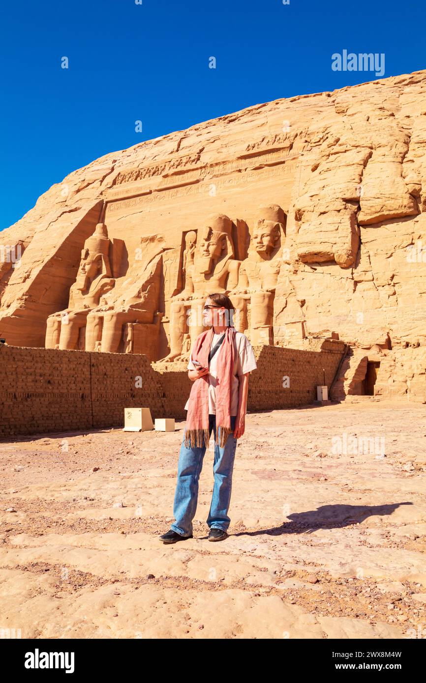 Woman tourist at Abu Simbel, the great temple of Ramses II. Nubia, Egypt - October 19, 2023 Stock Photo