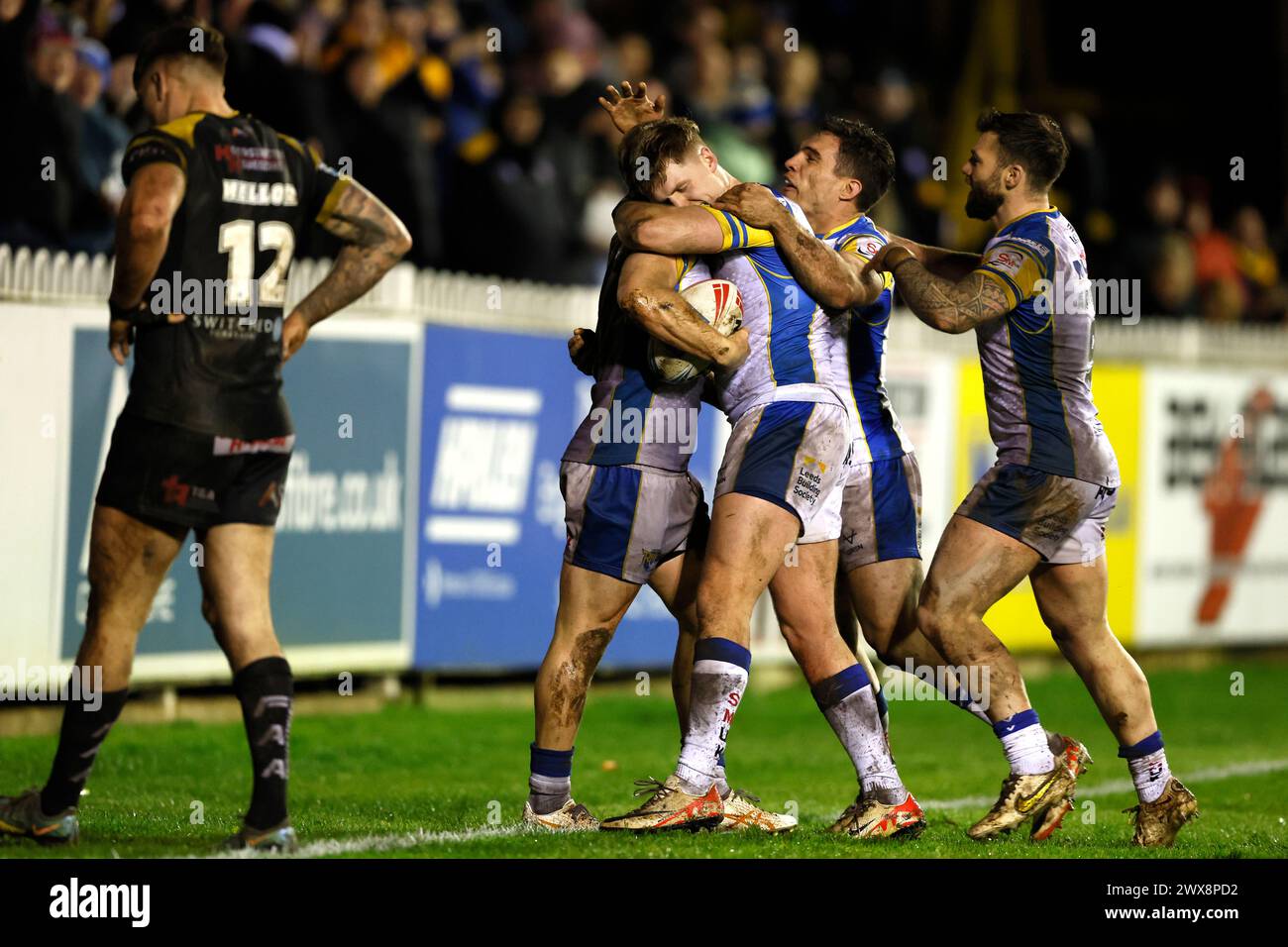 Leeds Rhinos' Lachie Miller (centre) celebrates scoring his side's third try of the game with team-mates during the Betfred Super League match at the Mend-A-Hose Jungle, Castleford. Picture date: Thursday March 28, 2024. Stock Photo